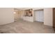 Open-concept living area with neutral carpet and modern light fixture open to the breakfast bar at 3145 E Flamingo Rd # 2119, Las Vegas, NV 89121