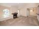 Cozy living room featuring a fireplace, neutral carpet, and arched windows with recessed seating at 3145 E Flamingo Rd # 2119, Las Vegas, NV 89121