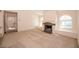 Spacious living room with a fireplace, arched windows, and adjacent doorway to the outside at 3145 E Flamingo Rd # 2119, Las Vegas, NV 89121