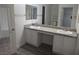 Bathroom featuring double sinks with granite countertop and vanity, wood-look flooring at 3507 Pointe Vedra Ct, Las Vegas, NV 89122