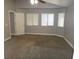 Spacious carpeted bedroom with three windows providing lots of natural light and an open doorway at 3507 Pointe Vedra Ct, Las Vegas, NV 89122