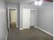 This bedroom has gray walls, carpet flooring, and a closet with sliding doors, all in a clean design at 3507 Pointe Vedra Ct, Las Vegas, NV 89122