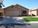Exterior shot of a one-story home with desert landscaping, a two-car garage, and a paved driveway at 3507 Pointe Vedra Ct, Las Vegas, NV 89122