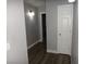 Hallway with wood-look flooring, grey walls, and modern lighting that guides you through the home at 3507 Pointe Vedra Ct, Las Vegas, NV 89122
