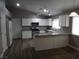 Bright kitchen features white cabinetry, granite countertops, stainless steel appliances, and new flooring at 3507 Pointe Vedra Ct, Las Vegas, NV 89122