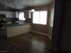 Modern kitchen with stone countertops, an island, and wood-look flooring, perfect for cooking and dining at 3507 Pointe Vedra Ct, Las Vegas, NV 89122