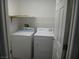 Compact laundry room with a washer, a dryer, and wire shelving for storage, maximizing functionality at 3507 Pointe Vedra Ct, Las Vegas, NV 89122