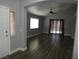 Open living room with hardwood floors, ceiling fan and view to outside through sliding glass doors at 3507 Pointe Vedra Ct, Las Vegas, NV 89122