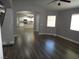Open floor plan living room with hardwood floors and view to kitchen and dining areas at 3507 Pointe Vedra Ct, Las Vegas, NV 89122
