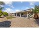 Spacious backyard with a covered patio, lush landscaping, and plenty of room for outdoor activities at 3561 Yorba Linda Dr, Las Vegas, NV 89122