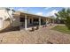 Relaxing backyard with a covered patio, well-maintained landscaping, and room for outdoor activities at 3561 Yorba Linda Dr, Las Vegas, NV 89122