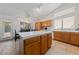 Bright eat-in kitchen featuring an island, wood cabinets, tile floors and countertops, and natural light at 3561 Yorba Linda Dr, Las Vegas, NV 89122