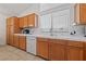 Kitchen showcasing countertops and wooden cabinets with white appliances at 3561 Yorba Linda Dr, Las Vegas, NV 89122