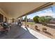 Enjoy the outdoors on this covered patio with a seating area and views of the backyard and desert landscaping at 3561 Yorba Linda Dr, Las Vegas, NV 89122