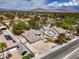 Aerial view showcases a property with well-maintained landscaping, complemented by desert scenery and mountainous vistas at 3710 E Oquendo Rd, Las Vegas, NV 89120
