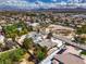 Aerial view showing a property with desert landscaping, mature trees, and nearby city at 3710 E Oquendo Rd, Las Vegas, NV 89120