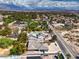 Beautiful aerial shot showcases neighborhood houses and scenic mountain views in the background on a partly cloudy day at 3710 E Oquendo Rd, Las Vegas, NV 89120