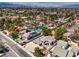 Aerial view of the neighborhood, showcasing tree-lined streets and nearby city at 3710 E Oquendo Rd, Las Vegas, NV 89120
