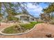 A manicured backyard offers desert landscaping, a small patch of lawn, and a stone-paved path at 3710 E Oquendo Rd, Las Vegas, NV 89120