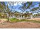Backyard featuring a well maintained lawn, mature trees, and an outdoor patio area at 3710 E Oquendo Rd, Las Vegas, NV 89120