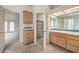 Well-lit bathroom with a walk-in closet, vanity, and shower with tile accent at 3710 E Oquendo Rd, Las Vegas, NV 89120