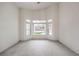 Brightly lit bedroom with natural light highlighting the space and backyard views through bay windows at 3710 E Oquendo Rd, Las Vegas, NV 89120