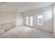 Upstairs bedroom with carpeted floors, a ceiling fan, and a private balcony at 3710 E Oquendo Rd, Las Vegas, NV 89120