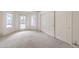 Airy bedroom featuring a door to the backyard and a large closet with folding doors at 3710 E Oquendo Rd, Las Vegas, NV 89120