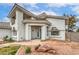A beautifully designed two-story home with rock landscaping and an inviting entrance at 3710 E Oquendo Rd, Las Vegas, NV 89120
