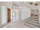 Bright foyer featuring tiled floors, a staircase, and a second-story balcony overlooking the entrance at 3710 E Oquendo Rd, Las Vegas, NV 89120