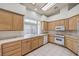 This kitchen is equipped with tile countertops, an oven, microwave, and ample cabinet space at 3710 E Oquendo Rd, Las Vegas, NV 89120