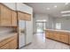 Open kitchen featuring lots of storage, an island with seating, and stainless steel refrigerator at 3710 E Oquendo Rd, Las Vegas, NV 89120