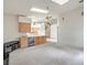 Spacious living room with a wet bar, ceiling fan, and multiple skylights for plenty of natural light at 3710 E Oquendo Rd, Las Vegas, NV 89120