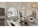Bright, open living room featuring a white piano, modern furniture and staircase to a second floor at 3710 E Oquendo Rd, Las Vegas, NV 89120