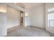 Neutral room with carpet, off-white walls, and two sconces at 3710 E Oquendo Rd, Las Vegas, NV 89120