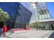 Modern building exterior with sharp angles, glass walls, minimalist planters, and gray cushioned benches and a sign at 3722 Las Vegas Blvd # 2204, Las Vegas, NV 89158