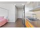 Modern kitchen featuring stainless steel appliances and a bedroom with pink bedspread in a condo at 3722 Las Vegas Blvd # 2204, Las Vegas, NV 89158