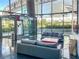 Symmetrical view of a modern lobby space with blue couches, glass doors, shiny floor, and greenery outside at 3722 Las Vegas Blvd # 2204, Las Vegas, NV 89158