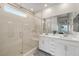 Modern bathroom featuring dual sinks, a spacious walk-in shower, and sleek, tiled surfaces at 4096 E Cactus Canyon Dr, Pahrump, NV 89061