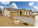 Inviting single-story home with a well-manicured front yard and a brick-paved driveway at 4096 E Cactus Canyon Dr, Pahrump, NV 89061