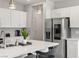 Bright kitchen with stainless steel appliances, white cabinets, modern pendant lights, and a large island at 4096 E Cactus Canyon Dr, Pahrump, NV 89061