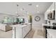 Open-concept kitchen and living area with a central island, stainless steel appliances, modern lighting, and comfortable seating at 4096 E Cactus Canyon Dr, Pahrump, NV 89061
