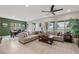 Spacious living room with large windows offering great natural light, a ceiling fan, comfortable seating, and backyard view at 4096 E Cactus Canyon Dr, Pahrump, NV 89061