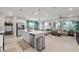 Open-concept living room with tile floors, neutral tones, large windows offering view, kitchen island and pendant lights at 4096 E Cactus Canyon Dr, Pahrump, NV 89061