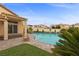 Fabulous backyard boasts a sparkling pool, artificial turf, and a large covered patio at 4105 Falcons Flight Ave, North Las Vegas, NV 89084