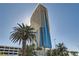 Luxury high-rise exterior with modern architecture and tropical palm trees in front at 4381 W Flamingo Rd # 2608, Las Vegas, NV 89103