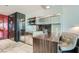 Compact kitchenette with stainless steel appliances, marble tile floors, and seating area at 4381 W Flamingo Rd # 2608, Las Vegas, NV 89103