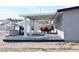 Outdoor patio area with dark wood deck, white awning, and seating, perfect for relaxing or entertaining at 4417 Rita Dr, Las Vegas, NV 89121