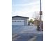 Home featuring a two-car garage, a long driveway, and neighborhood street view at 4417 Rita Dr, Las Vegas, NV 89121