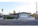 Single-story home featuring a two-car garage, concrete driveway, and manicured landscaping at 4417 Rita Dr, Las Vegas, NV 89121